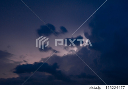 Evening thunderstorm with lightning in the mountains. Dramatic clouds during a thunderstorm pierce the light of lightning in a mountainous area. Evening thunderstorm with lightning in the mountains. Dramatic clouds during a thunderstorm pierce the light of lightning in a mountainous area. 113224477