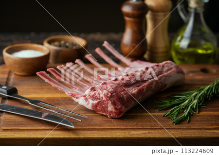 fresh lamb chop on wooden cutting board fresh lamb chop on wooden cutting board 113224609