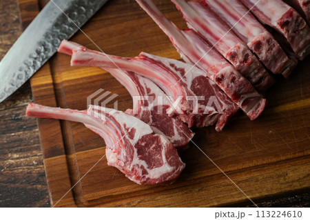 fresh lamb chop on wooden cutting board 113224610