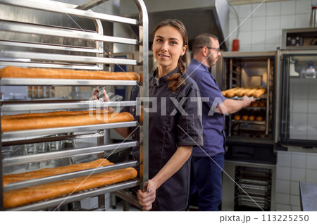 Man and woman preparing French baguettes 113225250