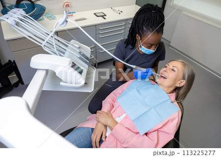 Woman patient receiving dental treatment 113225277