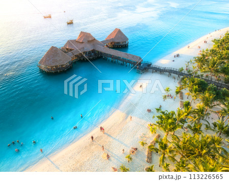 Aerial view of beautiful bungalow and sea at sunset in summer Aerial view of beautiful bungalow and sea at sunset in summer 113226565