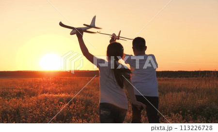 child airplane, children dream airplane pilot, child kid boy girl running with toy airplane across field, working team pilots, silhouette happy children running with toy airplanes hands, happy boy 113226728