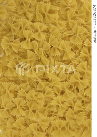 Background of raw Italian farfalle pasta close-up. Concept of pasta production. Background of raw Italian farfalle pasta close-up. Concept of pasta production. 113226874