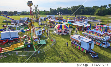 Aerial View of Festive Fairground with Amusement Rides and Food Stalls Aerial View of Festive Fairground with Amusement Rides and Food Stalls 113229783