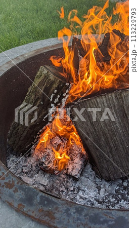 Campfire Glow with Fiery Logs and Embers, Outdoor Setting Campfire Glow with Fiery Logs and Embers, Outdoor Setting 113229793