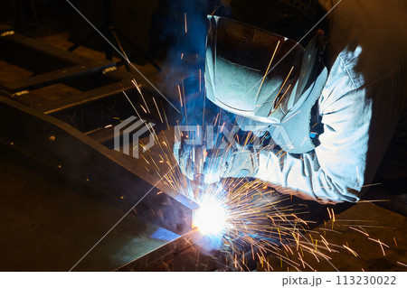 Industrial Welder at Work with Sparks Flying in Workshop 113230022