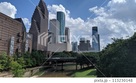 Vibrant Cityscape with Skyscrapers, Park, and River Bridge Vibrant Cityscape with Skyscrapers, Park, and River Bridge 113230148