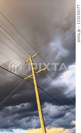 Dramatic Sky and Utility Pole with Power Lines, Low Angle View Dramatic Sky and Utility Pole with Power Lines, Low Angle View 113230277