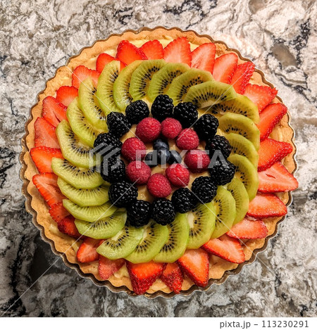 Colorful Fruit Tart with Fresh Berries on Marble - Top View 113230291