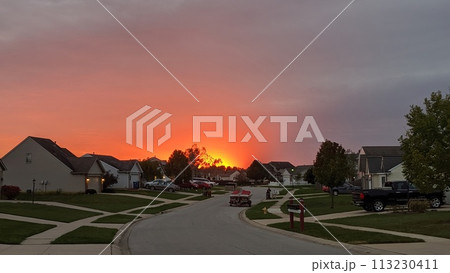 Suburban Sunset Glow with Autumn Trees and Family Homes 113230411
