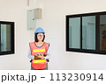 Asian women home Inspector surveyor wearing vests and hard hat at new property 113230914