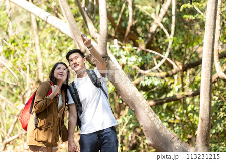 Tourist and traveler asian couple backpack enjoy and happy the jungle forest nature park. Tourist and traveler asian couple backpack enjoy and happy the jungle forest nature park. 113231215