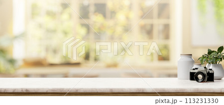 A space on a white marble tabletop with a blurred bright living room in the background. A space on a white marble tabletop with a blurred bright living room in the background. 113231330
