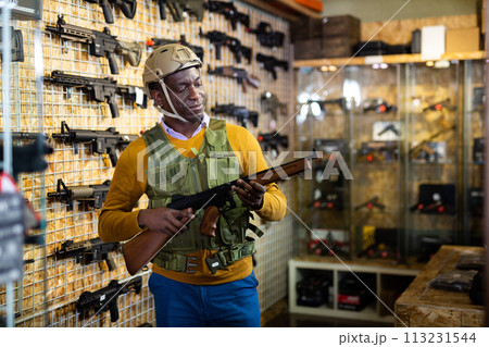 African-american man in weapon shop African-american man in weapon shop 113231544