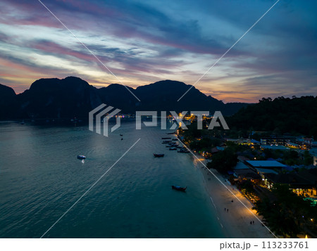 A stunning sunset over a small Phi Phi islands surrounded by sea and clouds 113233761