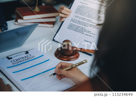 Businessman and lawyer discuss the contract document. Treaty of the law. Sign a contract business. Businessman and lawyer discuss the contract document. Treaty of the law. Sign a contract business. 113234649