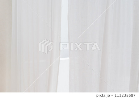 transparent curtain on window. white curtain wavy with a pattern background. real photo 113238687