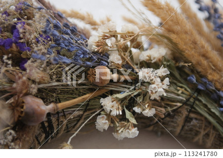 wreath of dried herbs Poppy spikelets of wheat predominance of blue dried herbs in decoration on the wall we will weave a wreath With love, handmade art Dried wildflowers create the atmosphere. wreath of dried herbs Poppy spikelets of wheat predominance of blue dried herbs in decoration on the wall we will weave a wreath With love, handmade art Dried wildflowers create the atmosphere. 113241780