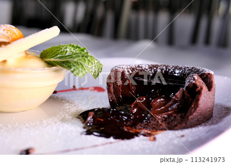 Chocolate fondant with strawberries, Chocolate fondant with strawberries and spoon on plate, isolated on white background, top view Chocolate fondant with strawberries, Chocolate fondant with strawberries and spoon on plate, isolated on white background, top view 113241973