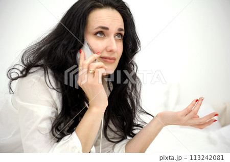 woman's face close-up in hands of phone unpleasant conversation emotionally raised eyes twisted lips on white background place for text unsuccessful order of discontent raise eyebrows wrinkle forehead woman's face close-up in hands of phone unpleasant conversation emotionally raised eyes twisted lips on white background place for text unsuccessful order of discontent raise eyebrows wrinkle forehead 113242081
