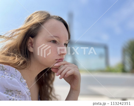 the face of a girl who sits against the backdrop of the Eiffel Tower she is thoughtfully relaxed beautiful there is a place for text for advertising the face of a girl who sits against the backdrop of the Eiffel Tower she is thoughtfully relaxed beautiful there is a place for text for advertising 113242351