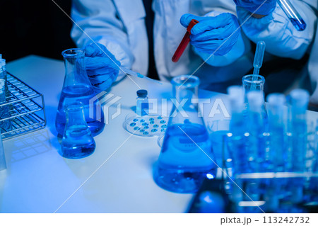 biotechnologist testing new chemical substances in a laboratory. biotechnologist testing new chemical substances in a laboratory. 113242732
