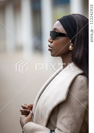 Elegant Woman with Sunglasses in Urban Setting 113242918