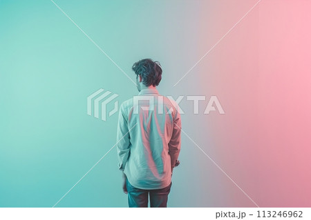 A man is standing in front of a wall with a pinkish blue background 113246962