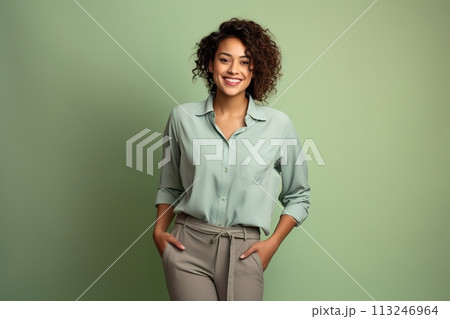A woman is wearing a green shirt and khaki pants 113246964