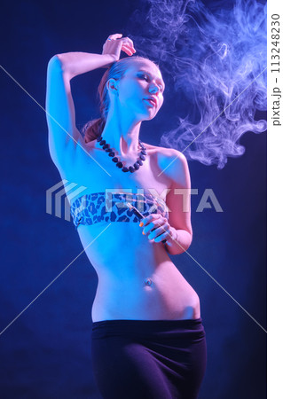 woman blowing smoke 113248230