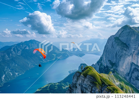 Happy paragliders flying on a paraglider, aerial view of flying paragliders Happy paragliders flying on a paraglider, aerial view of flying paragliders 113248441