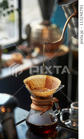 Barista brews drip brewing in a pour-over, close-up of a pour-over with hot water and filter paper, filtered coffee or pour over coffee 113248791