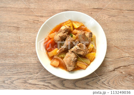fried mixed vegetable with chop pork bone in sweet and sour gravy sauce on white plate fried mixed vegetable with chop pork bone in sweet and sour gravy sauce on white plate 113249036