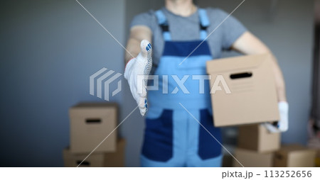 Male hand hold cardboard against new flat closeup Male hand hold cardboard against new flat closeup 113252656