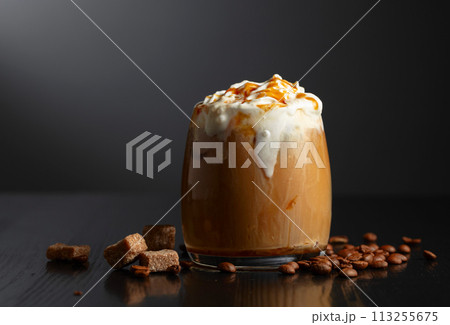 Iced coffee with whipped cream and caramel sauce. Iced coffee with whipped cream and caramel sauce. 113255675
