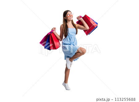 full length of teen girl at summer sale on background. photo of teen girl at summer sale with bags. full length of teen girl at summer sale on background. photo of teen girl at summer sale with bags. 113255688