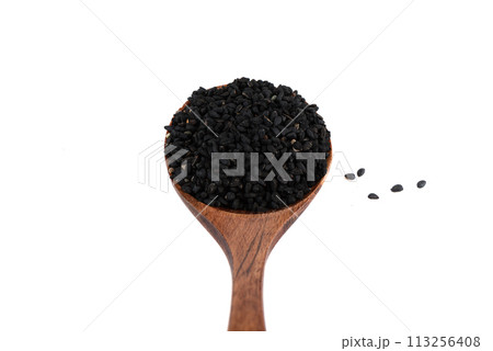 Close-up of wooden spoon with black sesame seeds over white background. Close-up of wooden spoon with black sesame seeds over white background. 113256408