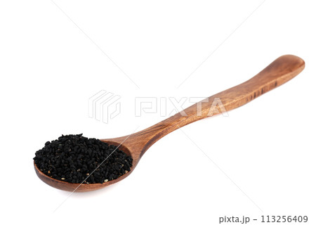Wooden spoon with black sesame seeds over white background. Wooden spoon with black sesame seeds over white background. 113256409