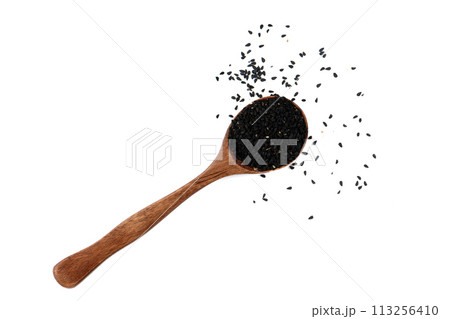 Top view black sesame seeds on spoon over white background. 113256410