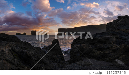 Picturesque autumn evening view Dyrholaey Cape, beach and rock formations. Vik, South Iceland. Picturesque autumn evening view Dyrholaey Cape, beach and rock formations. Vik, South Iceland. 113257346