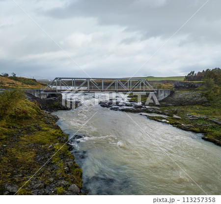 Hrutey island public park near Blonduos town, North-West of Iceland. View during auto trip by Ring Road. Spectacular Icelandic landscape with scenic autumn nature and Blanda river with cataracts. 113257358