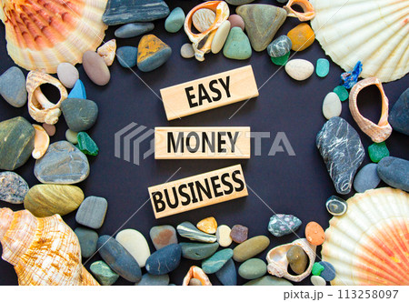 Easy money business symbol. Concept words Easy money business on beautiful wooden blocks. Beautiful black table black background. Sea shell stone. Easy money business concept. Copy space. Easy money business symbol. Concept words Easy money business on beautiful wooden blocks. Beautiful black table black background. Sea shell stone. Easy money business concept. Copy space. 113258097