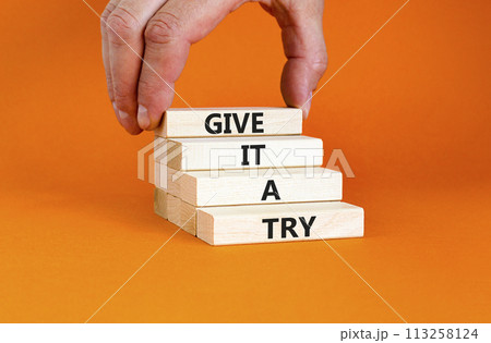 Give it a try symbol. Concept word Give it a try on beautiful wooden block. Beautiful orange table orange background. Businessman hand. Business give it a try concept. Copy space. Give it a try symbol. Concept word Give it a try on beautiful wooden block. Beautiful orange table orange background. Businessman hand. Business give it a try concept. Copy space. 113258124