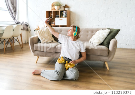 Full body photo of happy pretty girl sit floor inside home indoors with chicks Full body photo of happy pretty girl sit floor inside home indoors with chicks 113259373