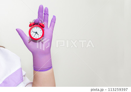 Cropped view of woman holding alarm clock  113259397