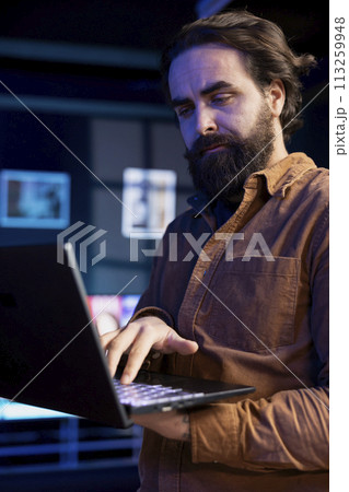 Computer technician doing software quality assurance, reading source code on laptop before implementing it. IT admin inspecting coding on notebook device, looking to fix potential issues Computer technician doing software quality assurance, reading source code on laptop before implementing it. IT admin inspecting coding on notebook device, looking to fix potential issues 113259948