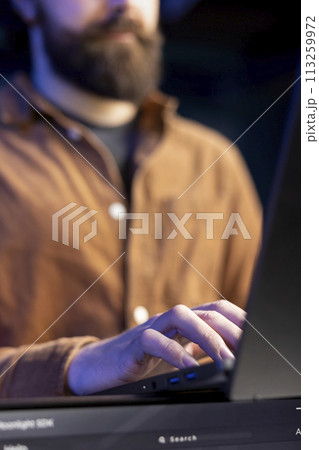 Teleworking programmer using laptop to filter malicious traffic from cybercriminals attempting to corrupt company data. IT administrator working on notebook, preventing malware and phishing attacks Teleworking programmer using laptop to filter malicious traffic from cybercriminals attempting to corrupt company data. IT administrator working on notebook, preventing malware and phishing attacks 113259972