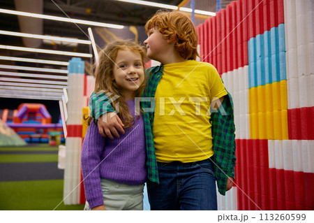 Cute little loving boy and girl children hugging together Cute little loving boy and girl children hugging together 113260599