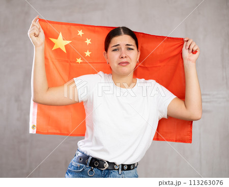 Sad girl upset by defeat of her favorite China team 113263076